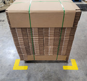 Large pallet locating corner on warehouse floor locating skid of boxes