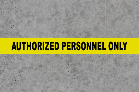 Authorized Personnel Only message tape on concrete floor