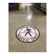 Pedestrian traffic only safety floor sign installed in warehouse walkway