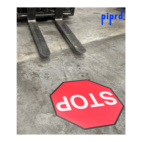 Stop floor sign on warehouse floor with forklift traffic