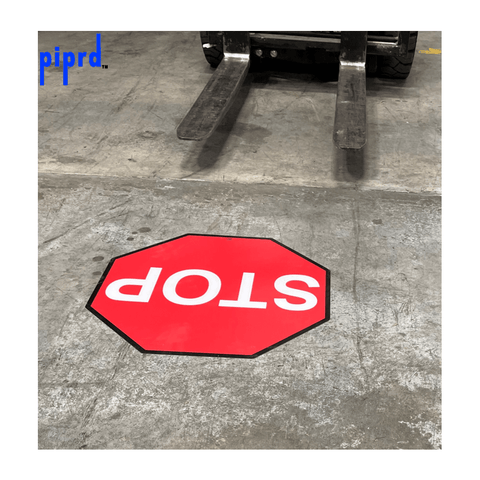 Forklift traffic stop sign for industrial floors. Red octagon STOP traffic sign in warehouse aisle