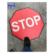Floor Stop sign for warehouse pedestrian and forklift traffic safety. Red octagon STOP floor sign installed on facility concrete floor