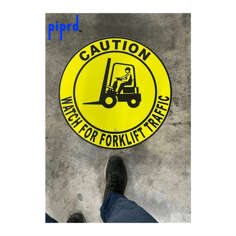 Floor sign for forklift traffic caution installed on warehouse floor for pedestrian safety