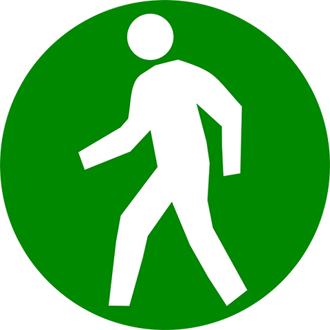 Pedestrian traffic floor sign. Green circle with white pedestrian walking