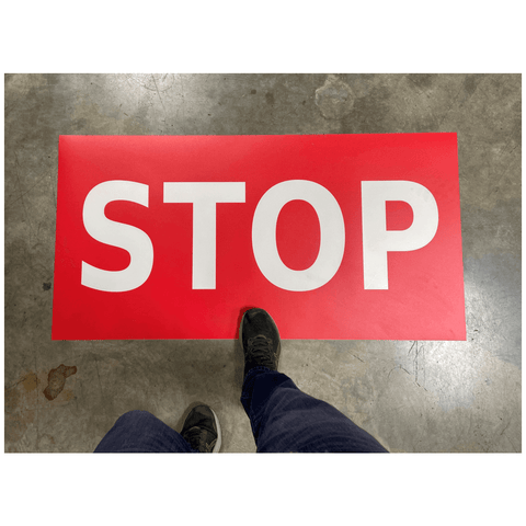 Adhesive Floor Stop sign installed on production floor for pedestrian traffic safety