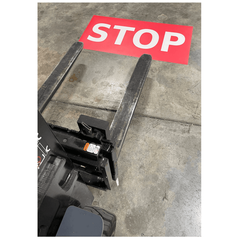 Stop Floor Sign installed on warehouse floor for forklift traffic safety
