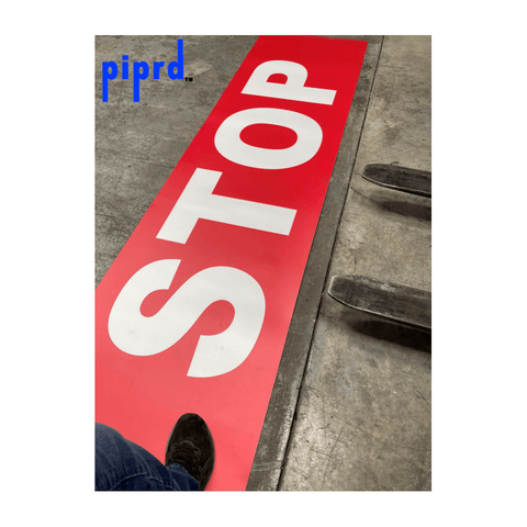 Large floor sign with stop message for industrial forklift and pedestrian traffic safety